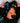 Baby wearing a colorful headband with jellyfish design and a black outfit.