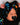 Baby wearing a colorful headband with jellyfish design and a black outfit.